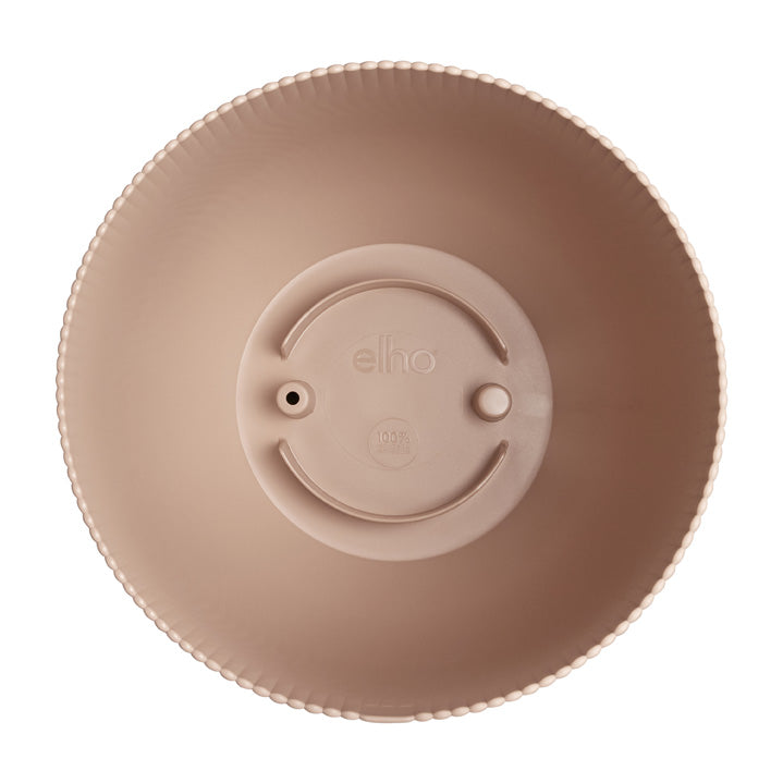Round beige object with 'elho' branding on a white background