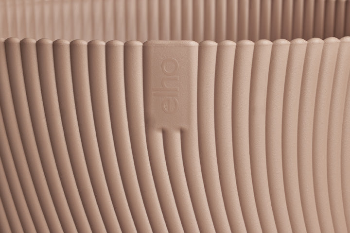 Close-up of a beige textured product with a brand logo.